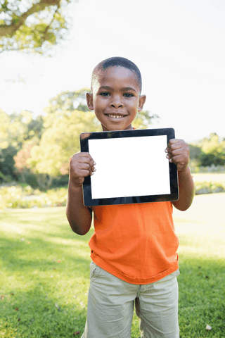 Smiling Boy Holding Blank Tablet with Transparent Screen Outdoors