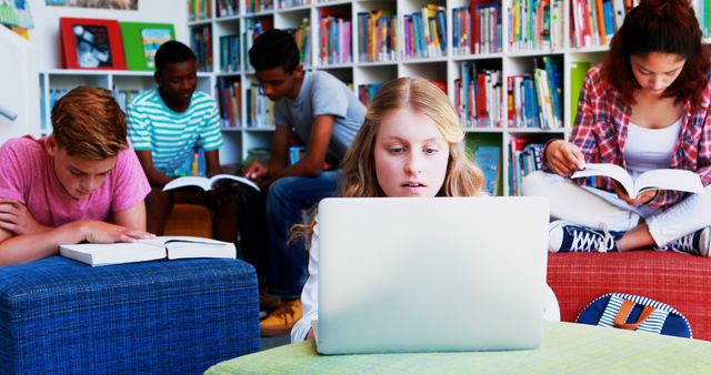 Diverse students studying in library with books and laptop - Download Free Stock Images Pikwizard.com