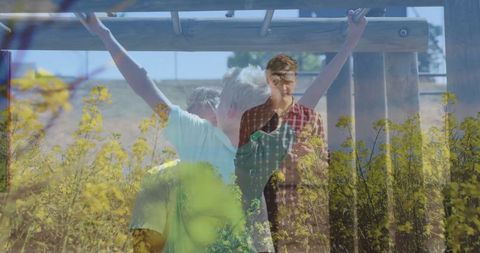 Child playing with wooden monkey bars and yellow flowers in background