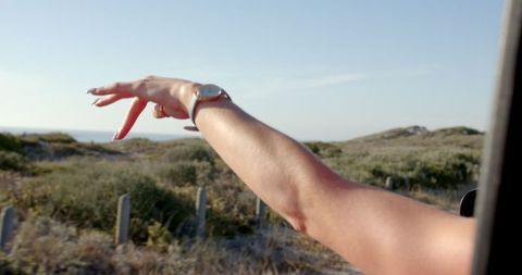 Hand Reaching Out Car Window Enjoying Road Trip Freedom