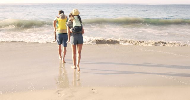 Young Family Walking on Beach Leaving Footprints in Sand - Download Free Stock Images Pikwizard.com