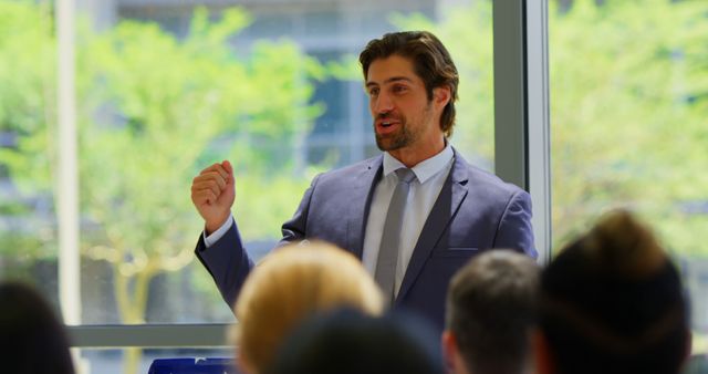 Confident Businessman Giving Speech in Modern Office Setting - Download Free Stock Images Pikwizard.com