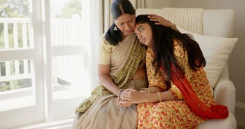 Mother comforting daughter affecting family bonding