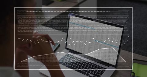 Business professional reviewing spreadsheet on laptop with HUD data visualization overlay