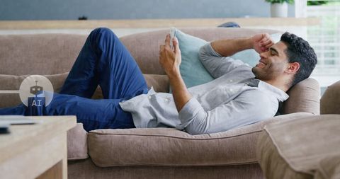Relaxed Man Enjoying Smartphone at Home with AI Interface - Download Free Stock Images Pikwizard.com