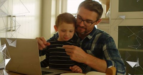 Father helping son learn on laptop at home, remote learning, family bonding and guidance