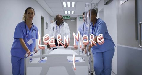 Medical team maneuvering stretcher in hospital corridor