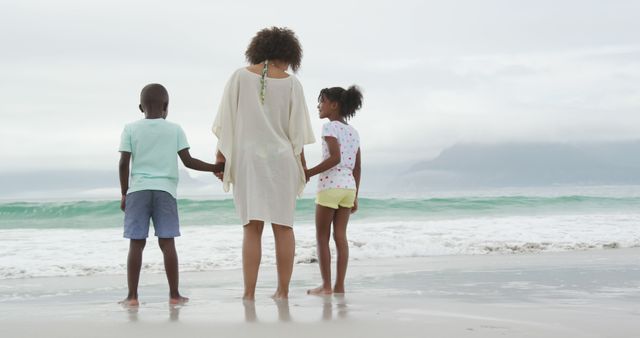 Mother Holding Hands with Children at Seaside - Download Free Stock Images Pikwizard.com