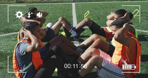 Diverse Athletes Training on Sunny Football Field