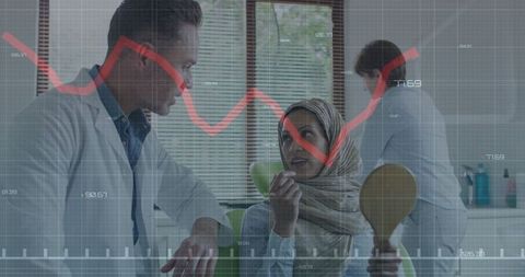 Dentist consulting headscarf patient with financial data overlay