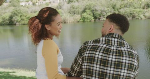 Couple Enjoying Leisure Time by Tranquil Riverbank