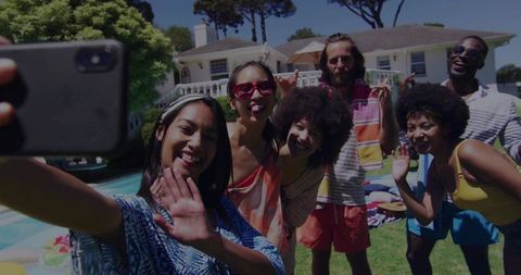 Friends Enjoying Summer Afternoon and Taking Selfie By Poolside Celebrating Vacation