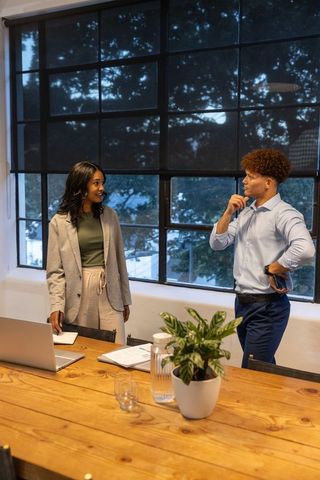 Diverse coworkers collaborating in modern conference room during business discussion