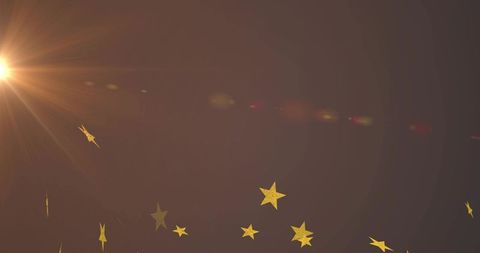 Golden Star Confetti Drifting with Warm Sunburst Lens Flare on Brown Gradient Backdrop