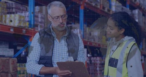Supervisor and Young Worker Reviewing Warehouse Inventory