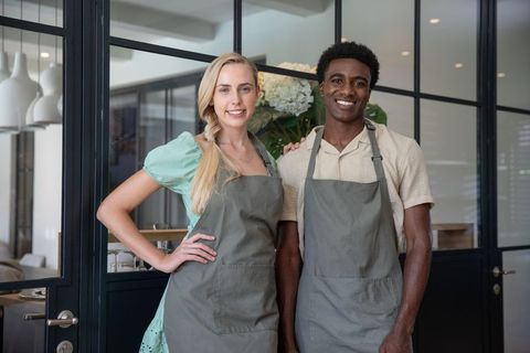 Smiling Diverse Cafe Coworkers in Stylish Workplace