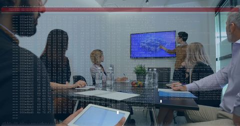 Diverse Business Team Analyzing Financial Data on Digital Screens