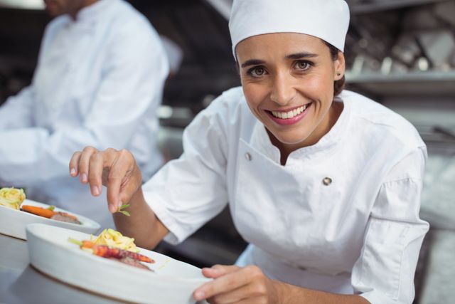 Female Chef Garnishing Dish in Restaurant Kitchen - Download Free Stock Photos Pikwizard.com
