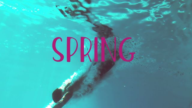 The video shows a swimmer in a swimming pool captured underwater with the word 'Spring' in prominent pink text. could use for fitness, sports, spring time, promotion or usage in aquatics, exercise, and swimming related materials.