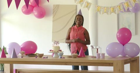 Woman Hosting Birthday Party with Colorful Decorations