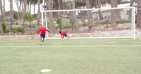 Diverse Kids Playing Soccer with Passion on Green Pitch
