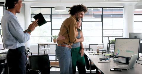 Diverse Team Celebrating Achievement in Modern Office Setting