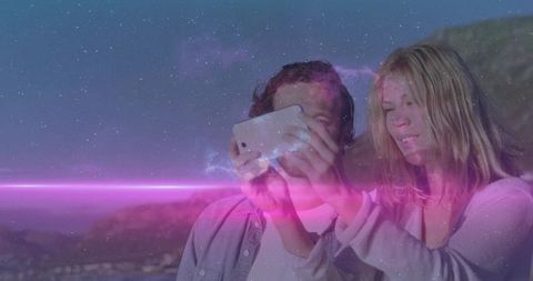 Couple Taking Selfie at Coastal Cliff with Cosmic Flare Effect