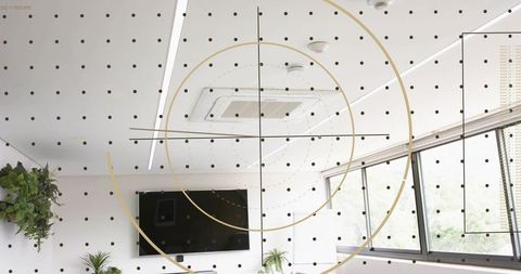 Minimalist office displaying gold concentric rings and dotted grid overlay, ui concept