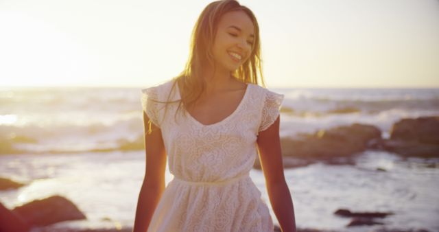 Smiling Young Woman at Sunset on Beach - Download Free Stock Images Pikwizard.com