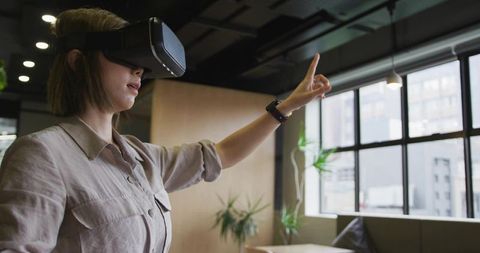 Woman Engaging in Virtual Reality Technology in Modern Office