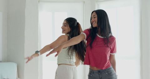 Diverse Friends Dancing and Stretching Joyfully in Sunlit Room