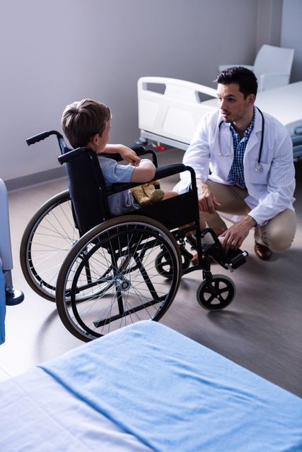 Doctor Interacting with Child in Wheelchair at Hospital - Download Free Stock Photos Pikwizard.com