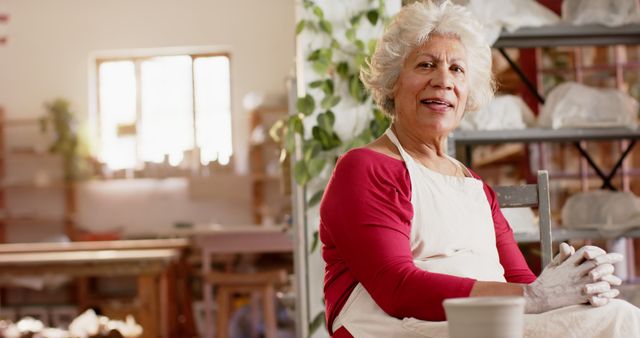 Senior Woman Working in a Pottery Studio Wearing an Apron and Smiling - Download Free Stock Images Pikwizard.com