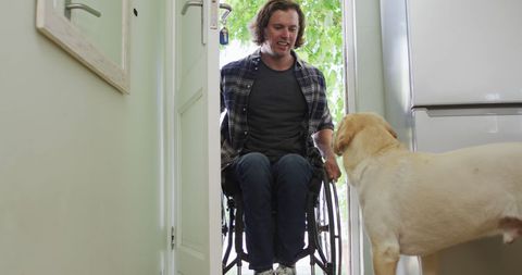 Man in Wheelchair Entering Home with Friendly Dog