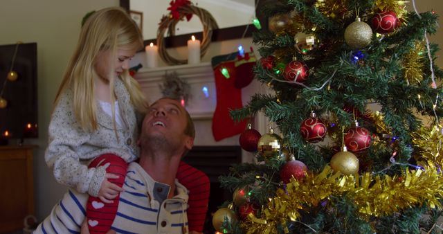 Father and Daughter Decorating Christmas Tree at Home with Joyful Expressions - Download Free Stock Images Pikwizard.com