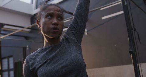 Focused Athlete Performing Kettlebell Overhead Exercise at Gym