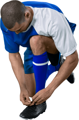 Athletic soccer player tying shoe laces with transparent background