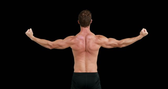 Rear view of caucasian strong man flexing muscles with copy space on black background. Boxing, strength, fitness concept.