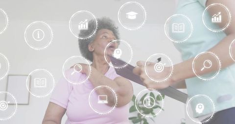 Senior woman rubbing shoulder while receiving telehealth home care consult with caregiver