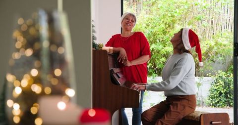 Family celebrating holiday joy with piano and santa hat
