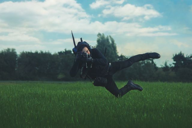 Spy suspended in mid-air capturing an action moment in grassy field. Useful for themes of espionage, adventurous photography, dynamic action sequences, and outdoor action activities.