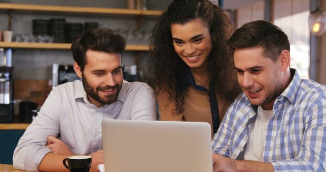 Group of Young Professionals Collaborating on Laptop in Coffee Shop - Download Free Stock Images Pikwizard.com