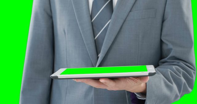 Businessman Holding Tablet with Green Screen in Suit - Download Free Stock Images Pikwizard.com