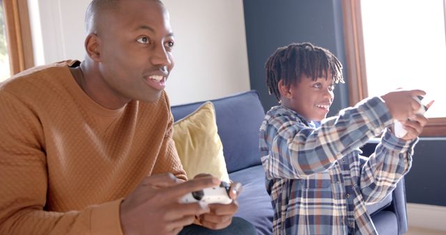 Father and Son Enjoying Video Games on Couch at Home - Download Free Stock Images Pikwizard.com