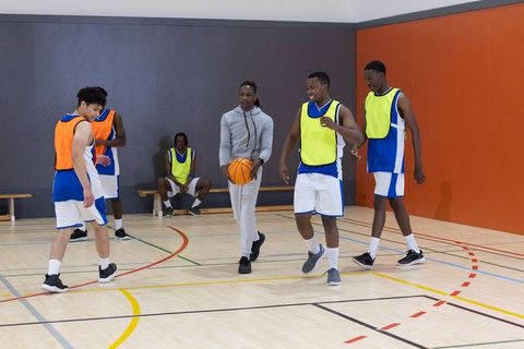Diverse Team Training on Indoor Basketball Court