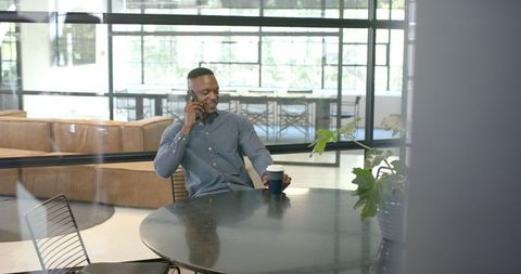 African American Professional Talking on Smartphone in Modern Office