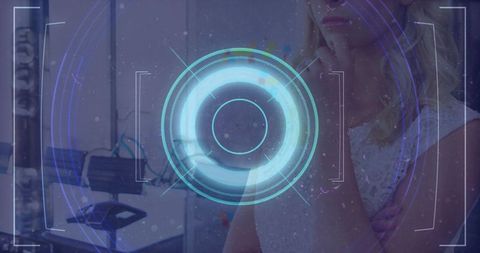 Contemplative woman holding chin studying holographic HUD overlay at office workstation