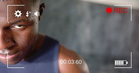 Close-up Male Athlete Sweating During Intense Studio Workout With Camera REC Overlay