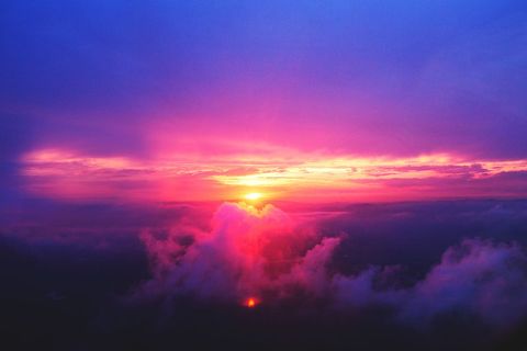 Sunset Sky Glowing Over Cloudscape with Vibrant Pink Purple Hues and Golden Horizon