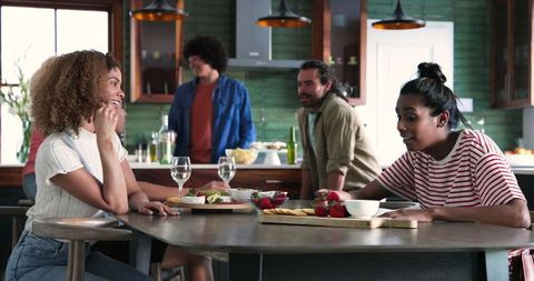 Diverse Friends Gathering with Wine and Food in Kitchen